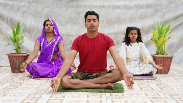 Close up of mindful young family with children sit meditate with mudra hands practice yoga.
