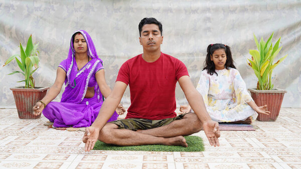 indian family doing meditation on the floor. Good life habit, healthy lifestyle, yoga practice with children at home