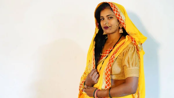 indian woman wearing saree or sari standing cross arms isolated over studio background