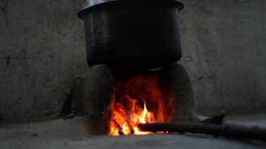 Ateş markası ya da melon şapkalı şenlik ateşi kulübede kamp ateşinin üzerinde statik ot çekimi, Hint usulü yemek pişirme. Parazit