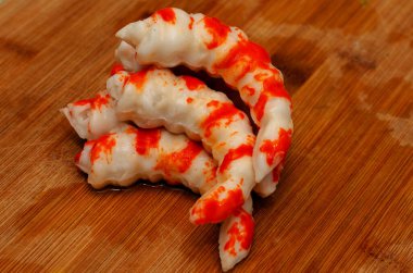 Crab sticks on a wooden hand. Surimi for food.