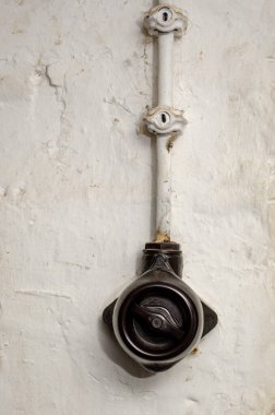 Vintage switch on the wall with a wire