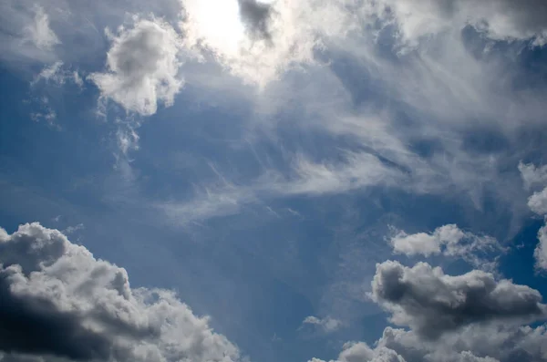 stock image cumulus clouds against the blue sky, houses, forests, and fields in germany.