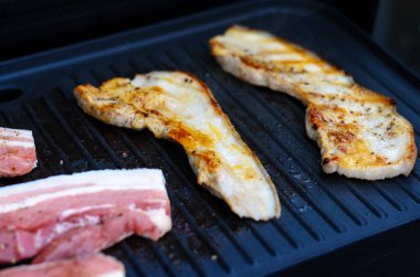 Lezzetli yağ dokusunu gösteren ızgarada kızartılmış domuz pastırması.