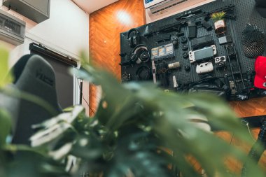 Bulanık elektronik çalışma alanı olan yeşil yaprakların sinematik yakın çekimi.