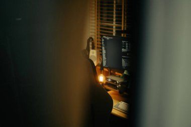 Pencere perdelerinden sinema masasına sessiz ve samimi bir bakış. Yumuşak, ılık ışıklar ve bulanık çizgiler nostaljik ve yansıtıcı bir atmosferi çağrıştırıyor..