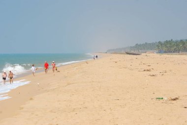 people at the sandy beach on the ocean coast