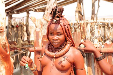 young african woman with a traditional costume in the desert
