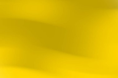 Yumuşak kıvrımlı ve eğimli soyut sarı arkaplan sıcak ve davetkar bir atmosfer yaratıyor.