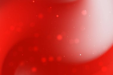 Yumuşak kıvrımlı soyut kırmızı arkaplan ve ışıldayan parçacıklar canlı bir atmosfer yaratıyor
