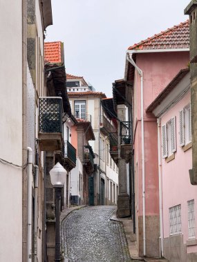 Portekiz, Porto 'da balkonlu eski pembe binalar arasında dar bir kaldırım taşı geçidi..