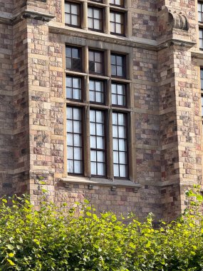 Historic stone brick building in Stockholm with detailed window design.