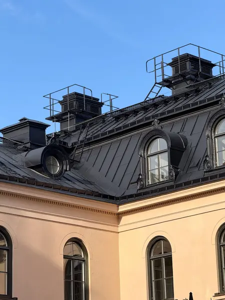 Architectural detail of a Stockholm building with classic black tiled roof.