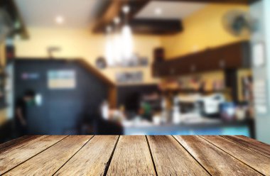 Seçilen odak boş kahverengi ahşap masa ve kahve dükkanı veya restaurent arka plan bulanıklık. Fotomontaj veya ürün ekran. Kopya alanı herhangi bir tasarım için