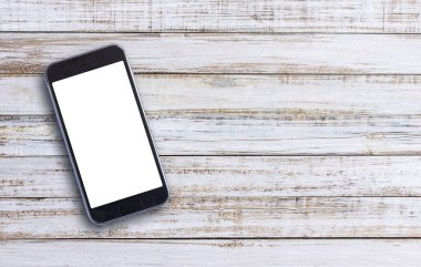 Beyaz ahşap arka plan kopya alanı ile akıllı telefon. Üstten Görünüm