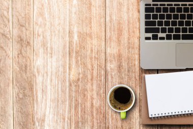 Modern ahşap ofis Resepsiyon Masa laptop, smartphone, fincan kahve ve malzemeleri. Kopya alanı için herhangi bir tasarım ile Üstten Görünüm