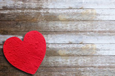 Ahşap masa arkasında kırmızı kağıt kalp. Herhangi bir tasarım için kopyalama alanı olan en üst görünüm.