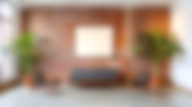 Şık, modern bir oturma odası, rahat bir kanepe ve koltuklar, kırsal tuğla bir duvara karşı kurulmuş, bereketli bitkiler ve boş bir çerçeve, huzurlu bir ortam yaratıyor..