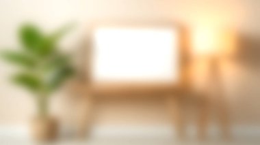 İçinde bitki, çerçeve ve lamba gibi modern dekor elementlerinin bulunduğu sakin bir iç mekan, herhangi bir yaşam alanı için sıcak ve davetkar bir atmosfer yaratıyor..