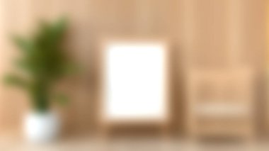 Huzurlu bir minimalist iç mekan, ahşap bir duvara karşı saksı bitkisinin yanında boş bir çerçeve sergiliyor. Tasarım ilhamı ve estetik projeler için mükemmel.