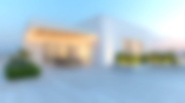 Bu çarpıcı görüntü, geniş pencereli, mavi gökyüzüne karşı yemyeşil, sükunet ve zarafeti simgeleyen modern bir minimalist evi sergiliyor..