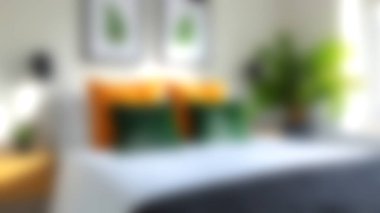 Çok güzel düzenlenmiş modern bir yatak odası. Canlı yastıklar ve yemyeşil bitkiler. Rahat ve konforlu bir ortam yaratıyor..