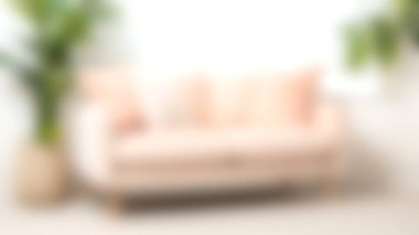 Bu resim, parlak minimalist bir oturma odasında ayarlanmış minderlerle süslenmiş yumuşak pembe bir kanepeyi yakalıyor. Dekor rahatlık ve sükuneti çağrıştırıyor. Rahatlamak için mükemmel..