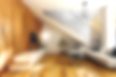 Bu resim, doğal ışık, sıcak ahşap aksanlar ve şık mobilyalarla dolu rahat ve modern bir oturma odasını sergiliyor. Rahatlamak için davetkar bir ortam yaratıyor..