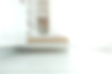 Doğal ışıkla dolu minimalist bir tasarım sergilenen bir iç mekanın yumuşak bulanık bir görüntüsü. Huzurlu ortam sükuneti ve zarafeti vurgular.