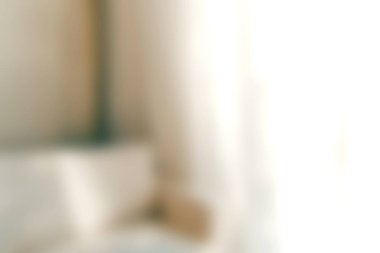 Bu yumuşak odaklı resim, doğal ışıkla dolu minimalist bir iç mekan sergiliyor, dinginlik ve rahatlık için mükemmel ve davetkar bir atmosfer yaratıyor..