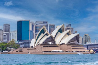Simgesel Sydney Opera Evi 'nin panoramik manzarası. Arka planda CBD silueti, gökyüzü, körfezden gelen turkuaz sular. Sydneys Central Business District 'in modern silueti. Avustralya 'nın en tanınan şehri. Dünya Mirası Alanı. NSW 'de. Sanat.