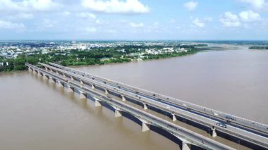 Indian bridge. aerial view of a long bridge on a river with busy city traffic.