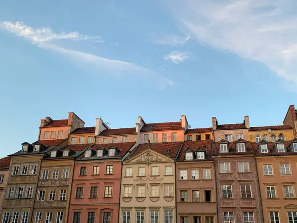 Açık mavi gökyüzünün altındaki renkli tarihi binalar.