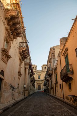 Nicolaci street with its decorated balcony  and Montevergine church in Noto, Sicly , Italy