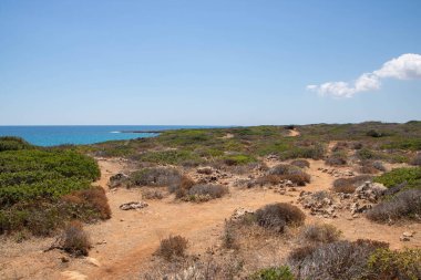 The path between sea and lagoon in the Vendicari Nature Reserve wildlife oasis, located between Noto and Marzamemi, Sicily, Italy