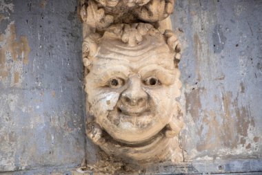 Caruso Palace characterized by what is considered one of the longest baroque balconies in the world. The wrought iron balcony is supported by twenty-seven carved corbels depicting funny masks with different expressions