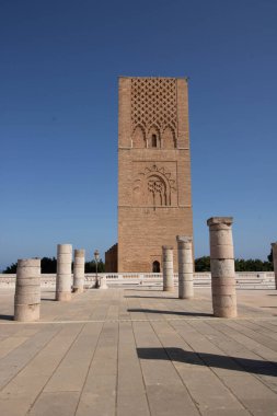 At Rabat Morocco, On 04, august, 2024,  Hassan tower , the minaret of an incomplete mosque commissioned by Abu Yusuf Yaqub al-Mansur, the third caliph of the Almohad Caliphate, in  the 12th century clipart