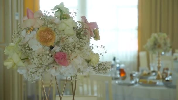 バラの花の美しいアレンジメント 結婚式で花の装飾 レストランのテーブルには花が咲いています — ストック動画