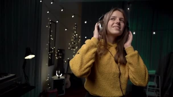 Girl Big Headphones Yellow Sweater Dancing Room — Stock Video