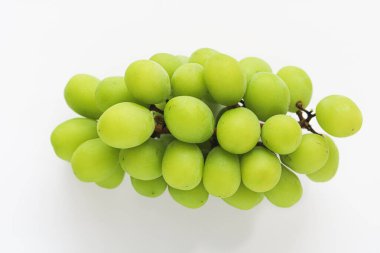 Closeup of a fresh bunch of green grapes, with a few visible stems, captured in a clean studio shot on a bright white background.