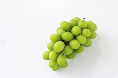 A fresh bunch of green grapes, with a few visible stems, captured in a clean studio shot on a bright white background.