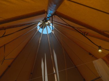 Kamp çadırı tavanının iç görünümü merkez direği ve kumaş yapısını içeriden gösteriyor