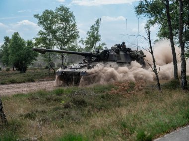 PZH2000NL topçuları doğal bitki örtüsünde hareket ederek toz bulutu yaratıyor.