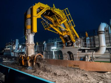 Sarı taramalı vinç gündüz deniz operasyonları sırasında suya batırılmış tortuları boşaltıyor.