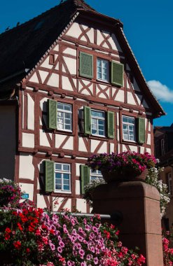 Editorial image of a traditional half-timbered house with green shutters and vibrant flowers in Mosbach, Germany. Photographed on 3 Sept. 2025, the scene reflects classic European architecture and rural charm.