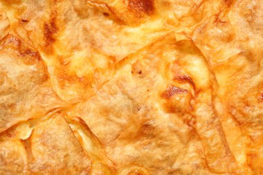 Top down view, extreme close up of delicious, homemade traditional Bulgarian breakfast called banitza. Macro food texture background