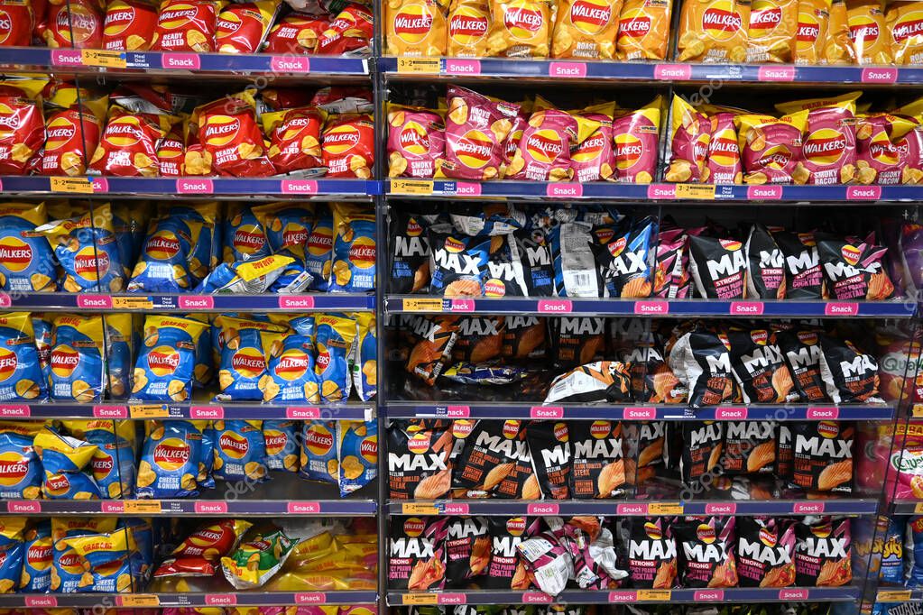 Different types of Walkers crisps single bags on shelf, England, UK