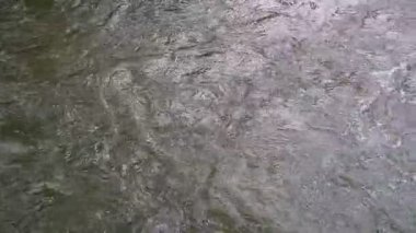 Şelale akıntıları kayalık yüzeylere çarparak çalkantılı dalgalar ve sürekli hareketler oluştururken doğanın gücü görülebilir. Görüntüler, akan suyun vahşi ve yabani güzelliğini vurguluyor.