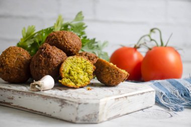 Falafel, ahşap arka planda domatesler