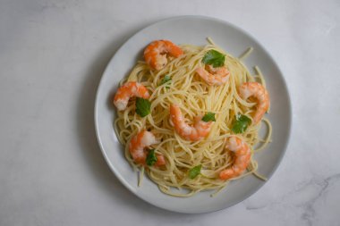 Arka planda karidesli spagetti.